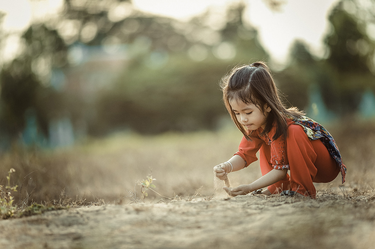 A Girl Playing with dirt