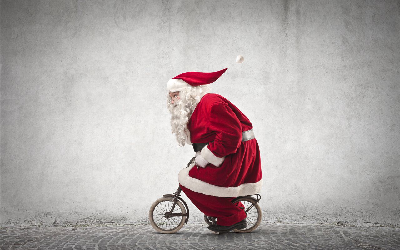 Santa Claus Riding a Small Bike