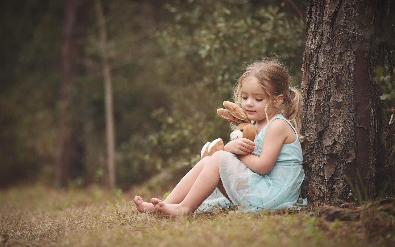 A Little Blonde Girl with Toy