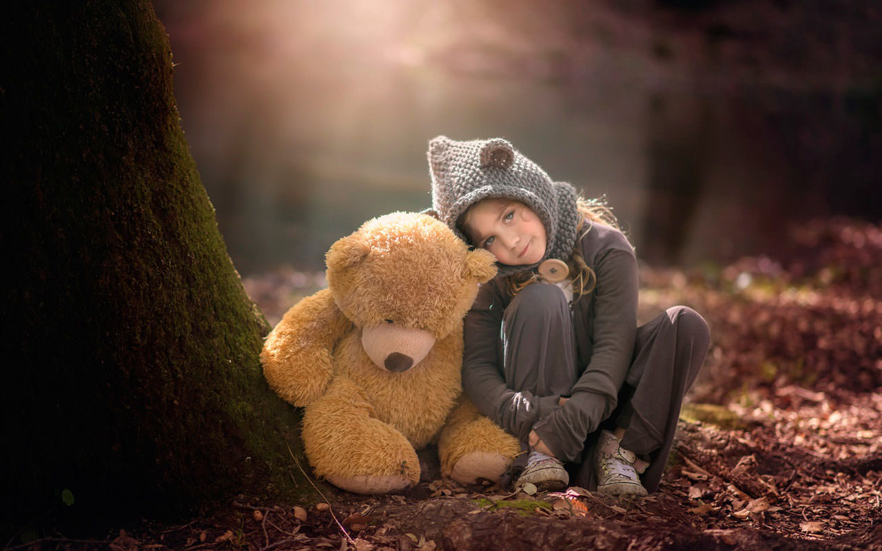 Cute Little Girl and Teddy Bear in Forest