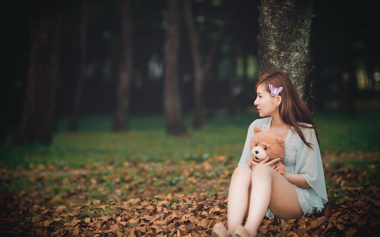 Asian Girl with Teddy Bear in Autumn