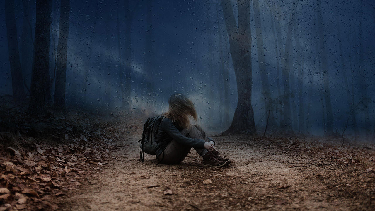 Lone Girl in the Dark Stormy Forest